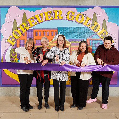 ribbon cutting at mural unveiling event