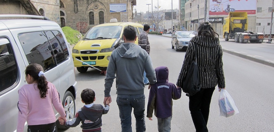 Family walking down street