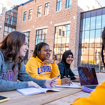 Students sitting at picnic table