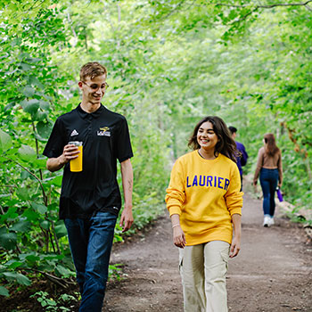 Laurier students walking in a forest