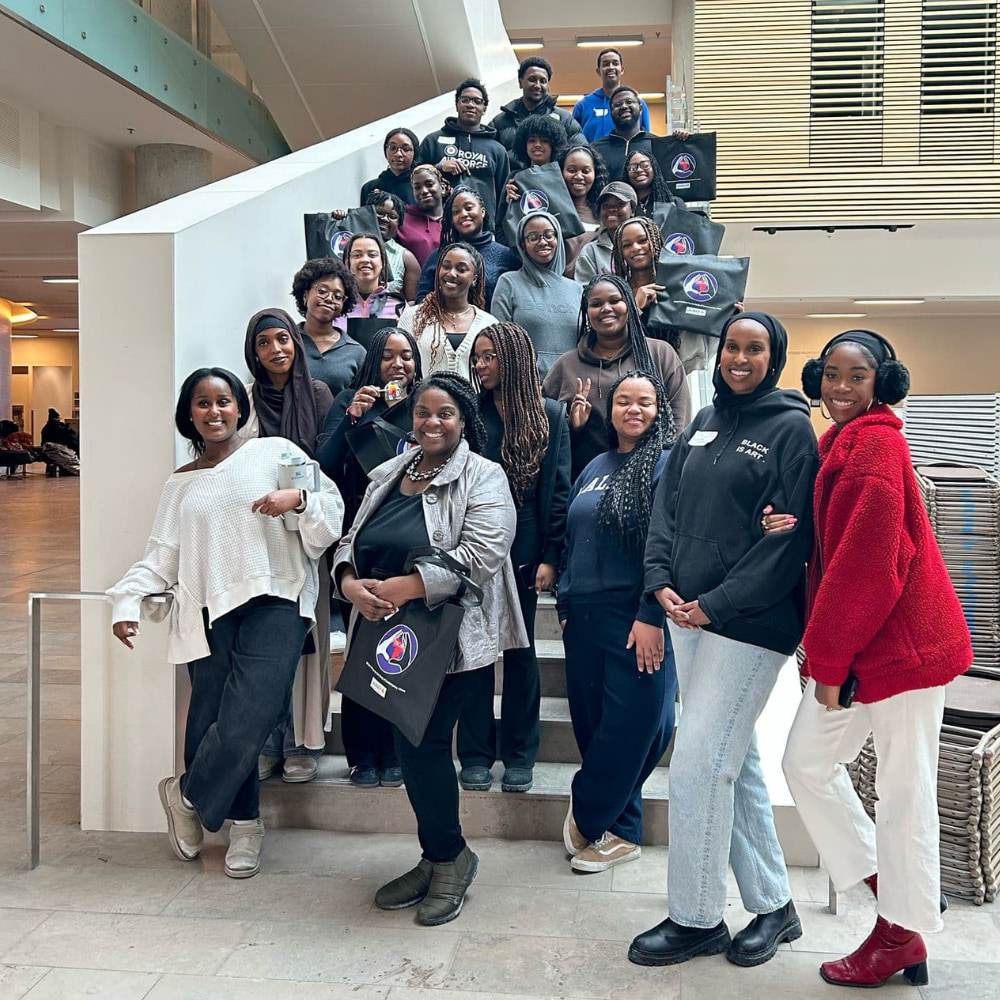 A large group of people gathered on stairs.