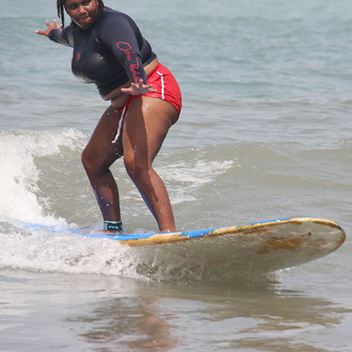 Young woman surfing on a wave