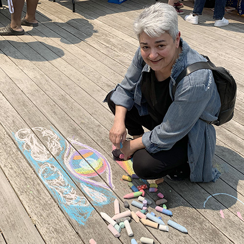 Gohar Ashoughian drawing with sidewalk chalk