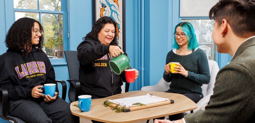 Students gathering for tea with staff