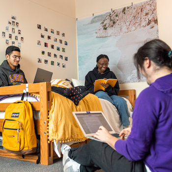 Female and male student studying outside.
