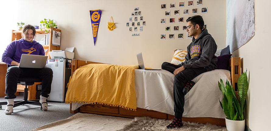 Two students sitting in a residence room