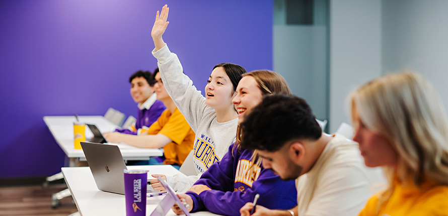 class of students learning in a purple-painted classroom