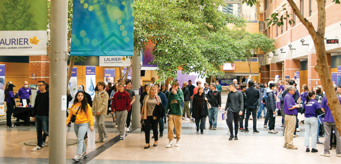 three students on waterloo campus in spring