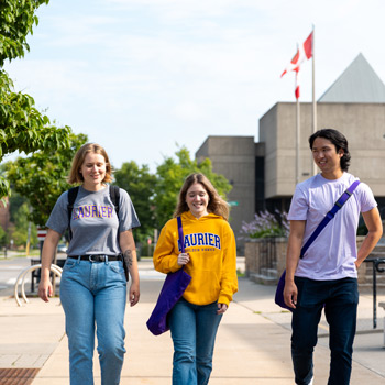 three students smiling walking in Brantford