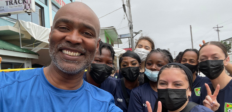 Ivan Joseph and female soccer players.