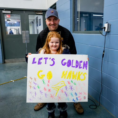 dan and his daughter cheering on the Golden Hawks
