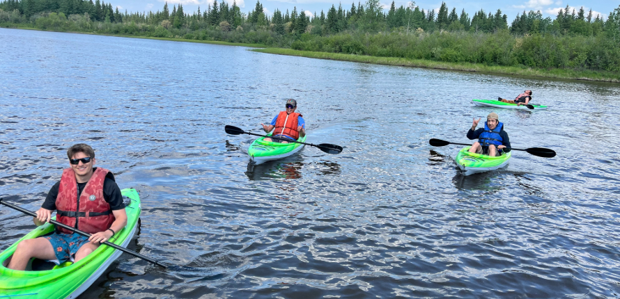 Uvakov and Sambaa K'e community members pose after a kayak race