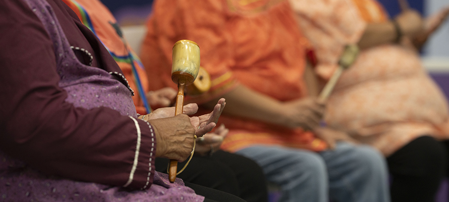 Close up of Indigenous performers holding musical instruments at MarketFest