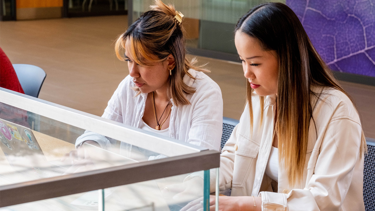 two students working in the lazaridis atrium