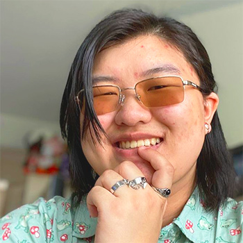 student with rings and green shirt