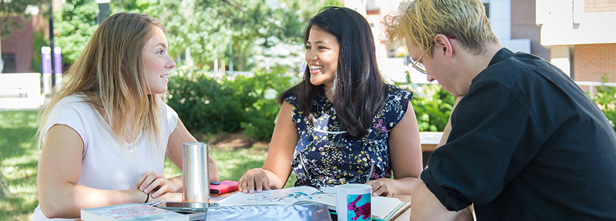 Students sitting around a table talking
